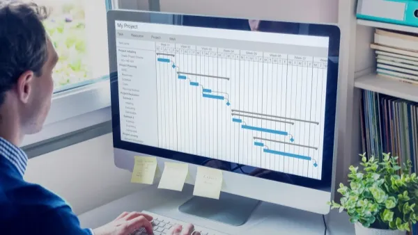 project dependency mapping banner: manager working on computer screen filled with tasks and subtasks